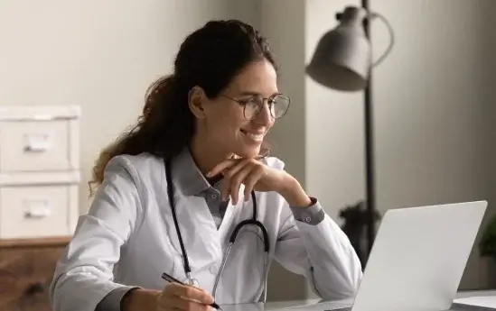 Doctor talking with her patient online over the laptop