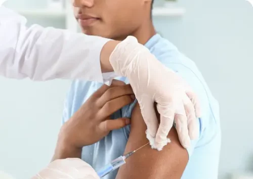 Doctor giving a young man an allergy shot