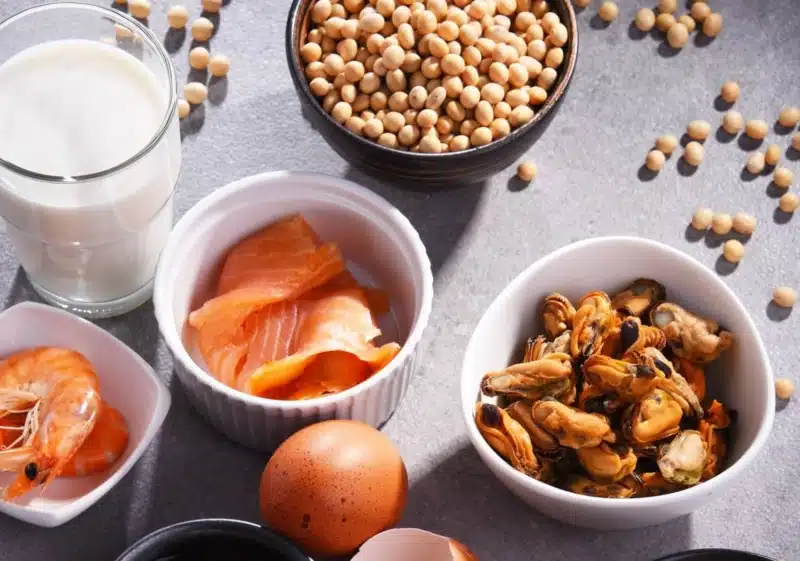 Examples of foods that can trigger allergies including milk, salmon, eggs and nuts