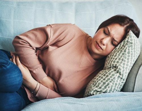 Woman in the bed with gastrointestinal disorder