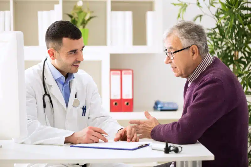 Doctor listening to patient explaining conditions.