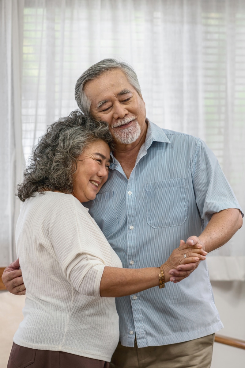 Asian couple Grandparent dancing and hugging together with happy feeling in AllerVie Clinic in Chelsea