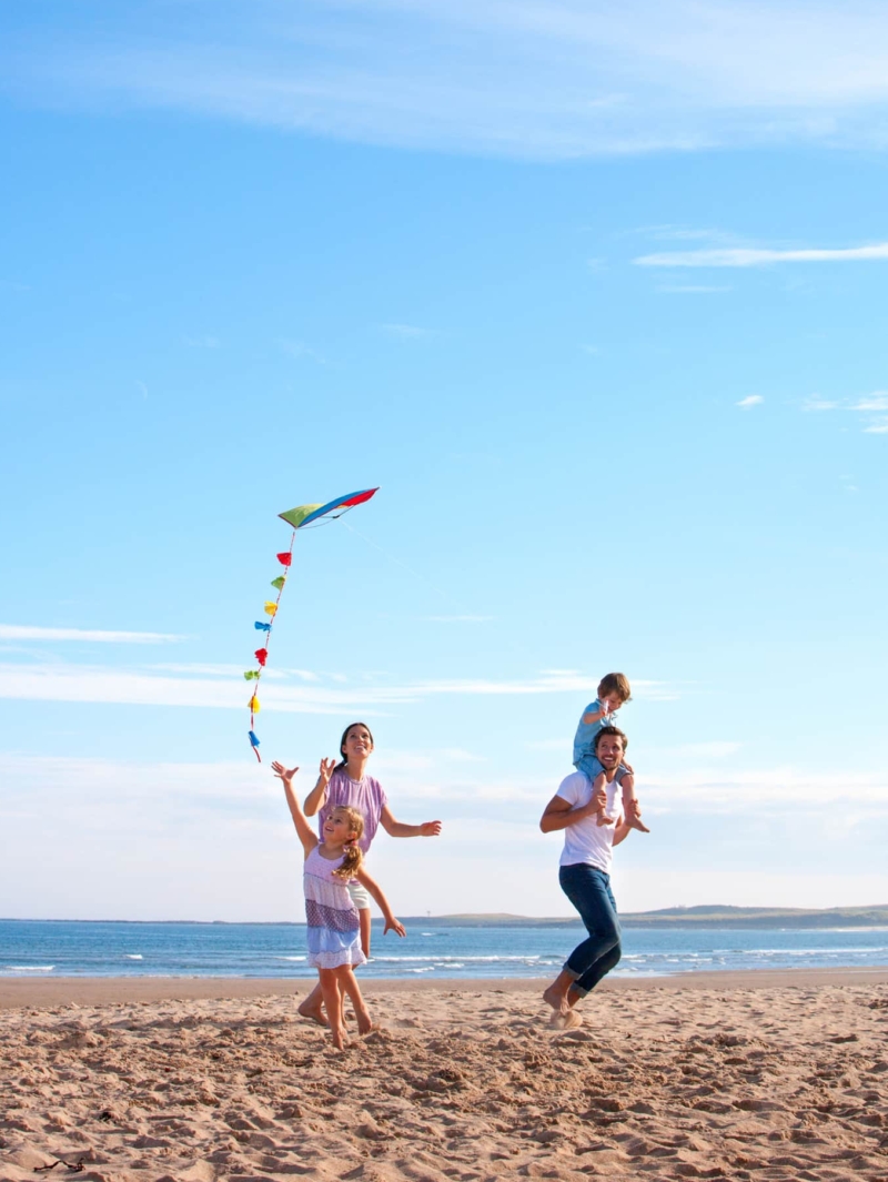 Happy family on the beach after visiting the AllerVie Health Florida