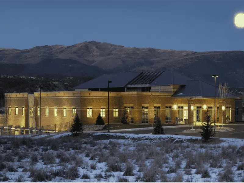 Allergy, Asthma & Immunology of the Rockies, P.C. - Eagle shot of outside of the clinic building, at night with moon and a little bit of snow