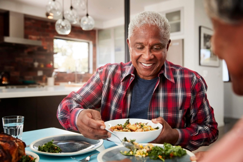 Senior Couple Enjoying a Healthy Meal Around Table At Home