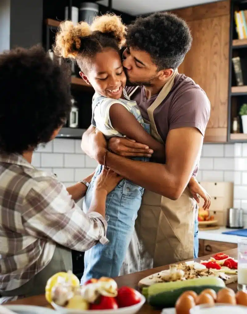 Happy African American family preparing healthy and allergy friendly food in kitchen together