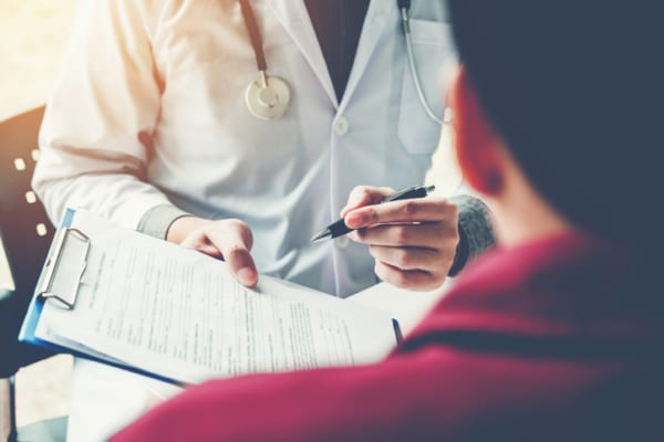 Doctor and patient filling out a form