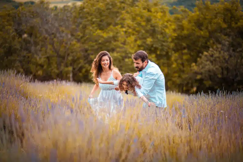 Family playing in a field of bluebells