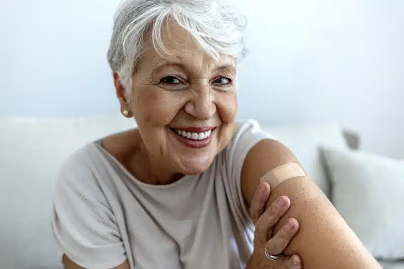 Woman with Band-Aid on her arm from allergy shot