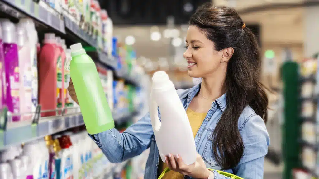 A woman choosing detergent at supermarket. 