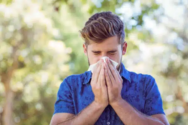 Man sneezing from Spring Allergies