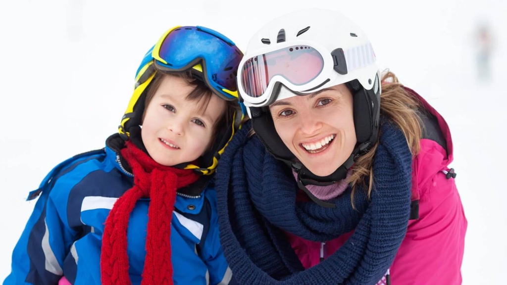 Mother and son out doors with ski or snowboard gear
