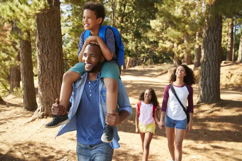 family hiking through the woods