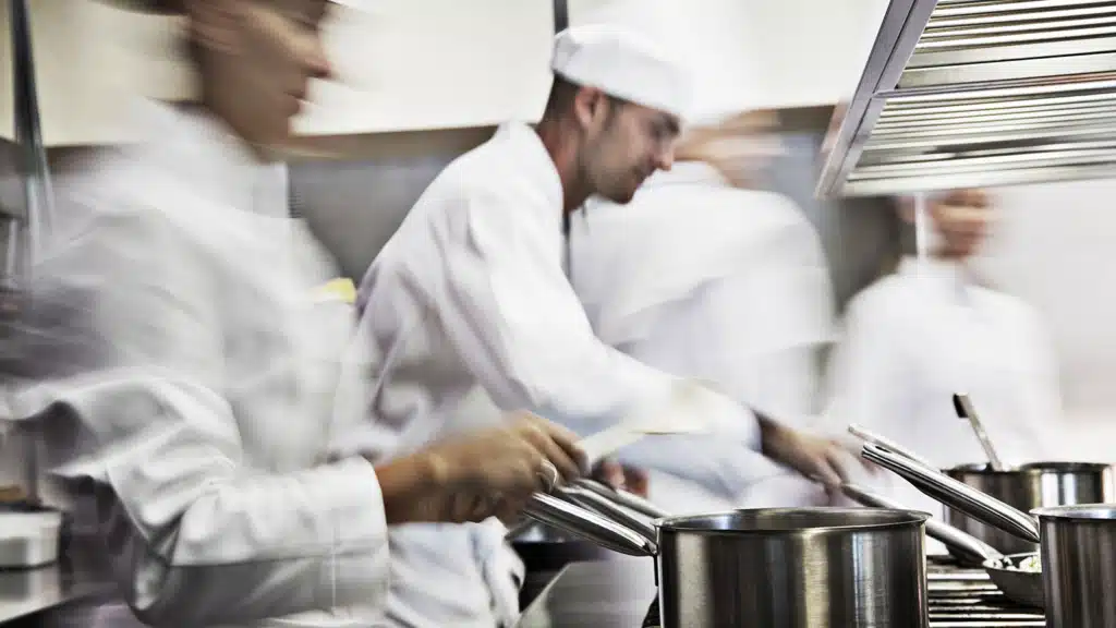 Cooks working in a kitchen restaurant over the stove