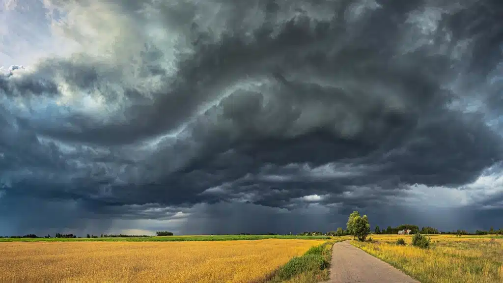 Open field with dark black clouds 